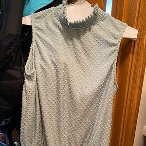 Dress shirt with ruffled bottoms and turtle neck style top.